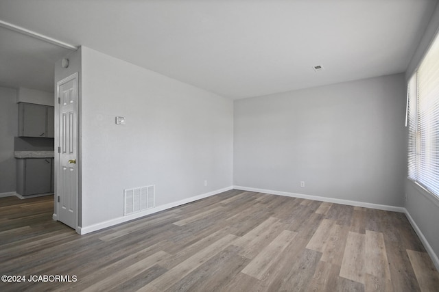 empty room with hardwood / wood-style flooring