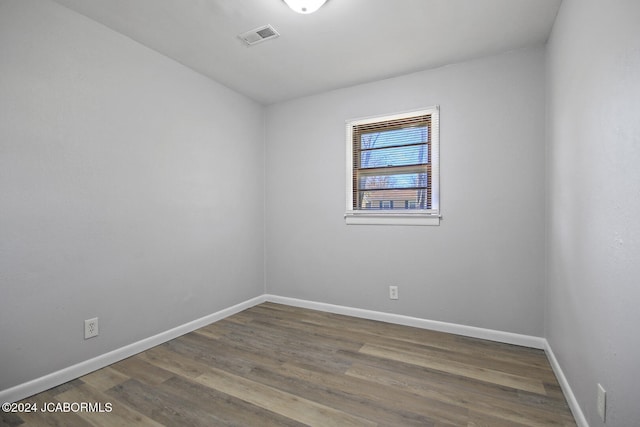 unfurnished room with wood-type flooring