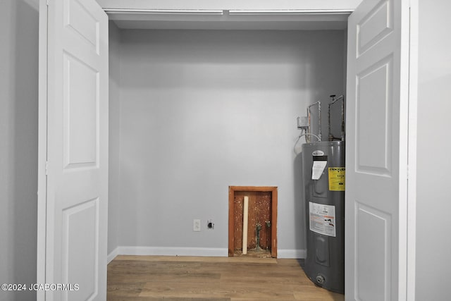 utility room featuring water heater