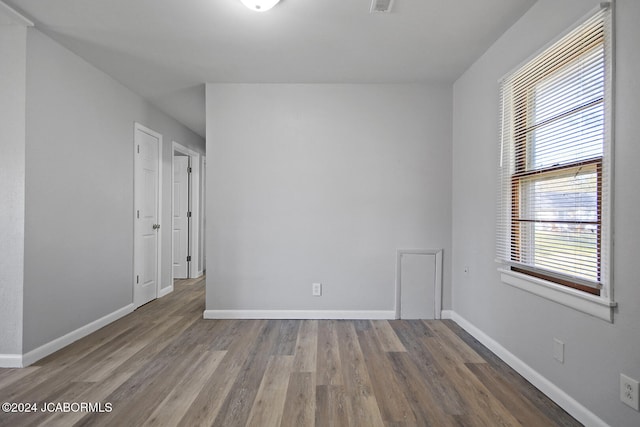 unfurnished room with hardwood / wood-style floors