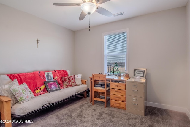 carpeted office space featuring ceiling fan