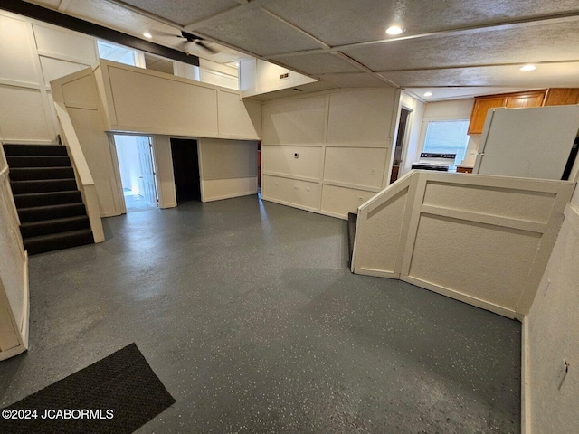 basement with white refrigerator