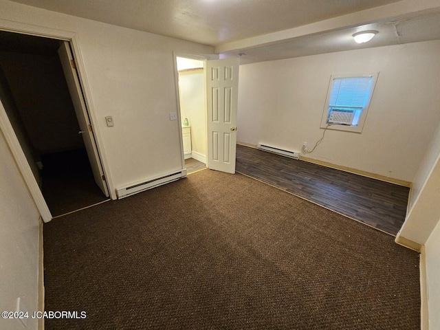 carpeted empty room with baseboard heating and cooling unit