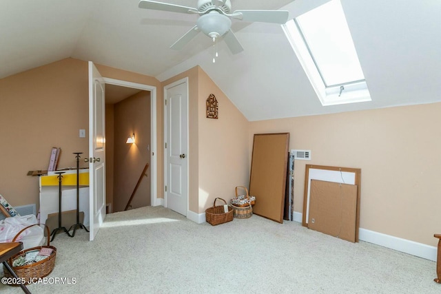 additional living space featuring lofted ceiling with skylight, carpet, and baseboards