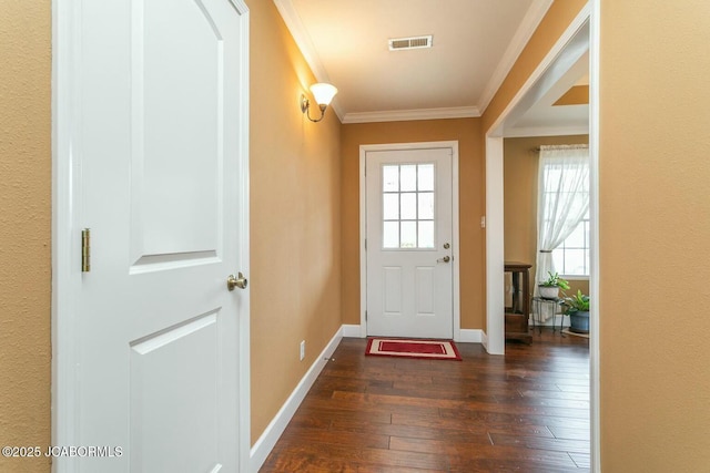 entrance foyer featuring dark wood-style flooring, visible vents, crown molding, and baseboards