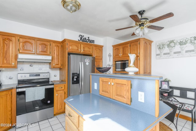 kitchen featuring decorative backsplash, light tile patterned floors, stainless steel appliances, and ceiling fan