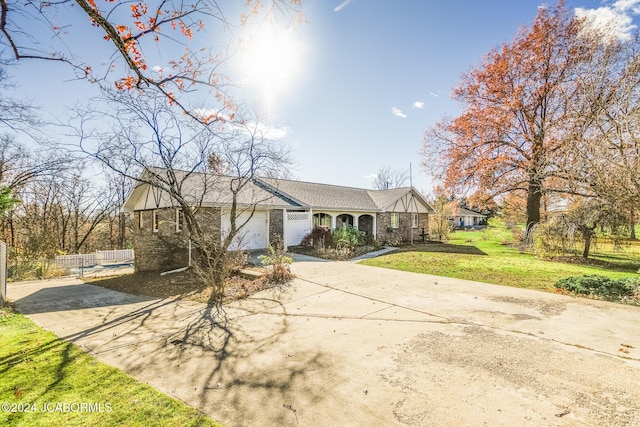 view of front of property with a front yard and a garage