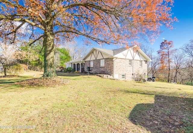 view of side of home with a lawn