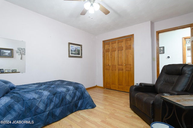 bedroom with ceiling fan, a closet, and light hardwood / wood-style flooring