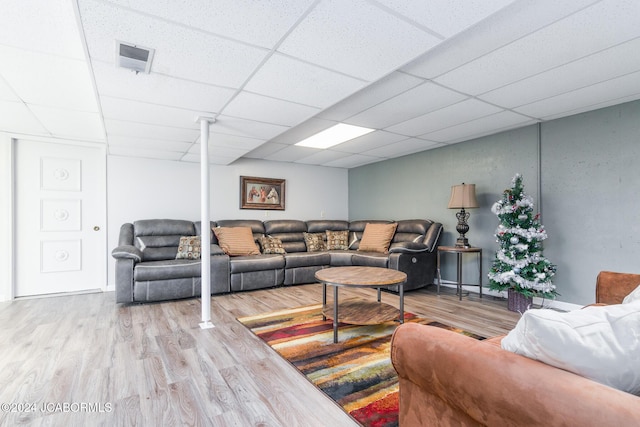 living room with a paneled ceiling and wood-type flooring