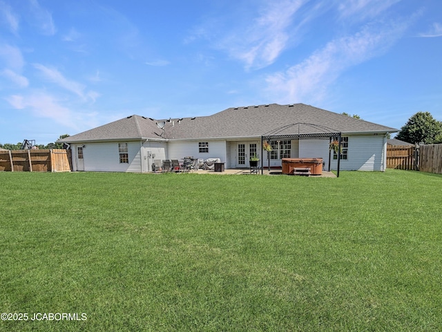 604 Mustang Dr, Ashland, MO 65010 - back of property featuring a hot tub, a patio area, a fenced backyard, french doors, and roof with shingles