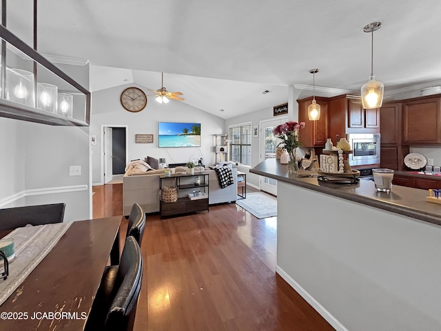 604 Mustang Dr, Ashland, MO 65010 - kitchen featuring open floor plan, stainless steel microwave, ceiling fan, dark wood-style flooring, and dark countertops