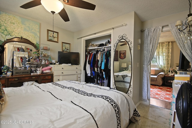 bedroom with ceiling fan, a closet, and a textured ceiling