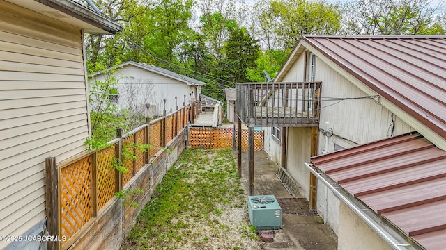 view of yard with a wooden deck and a fenced backyard