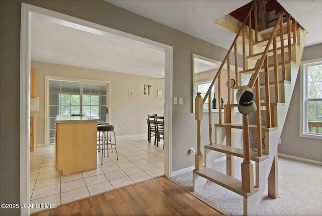 staircase with baseboards and wood finished floors