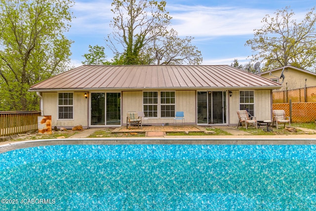 exterior space with a fenced in pool, a patio area, and fence