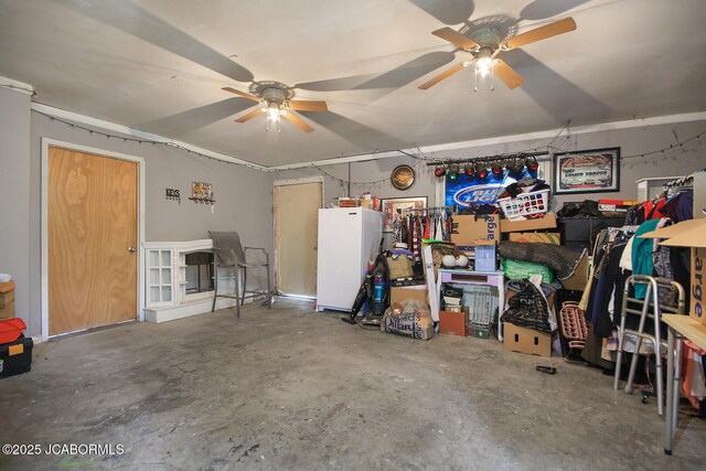7519 Stringtown Station Rd, Lohman, MO 65053 - garage featuring a ceiling fan and freestanding refrigerator
