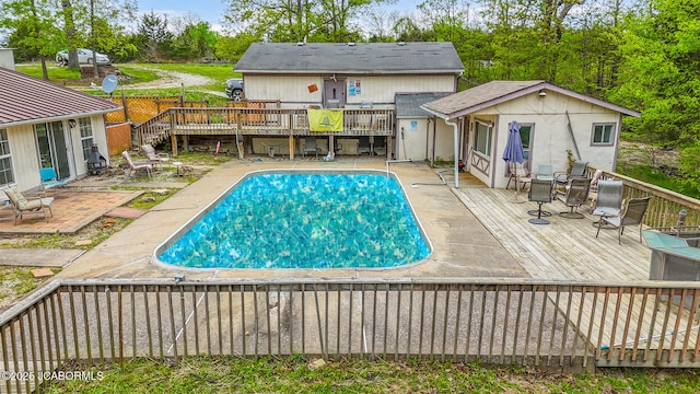 outdoor pool featuring a wooden deck and a patio area