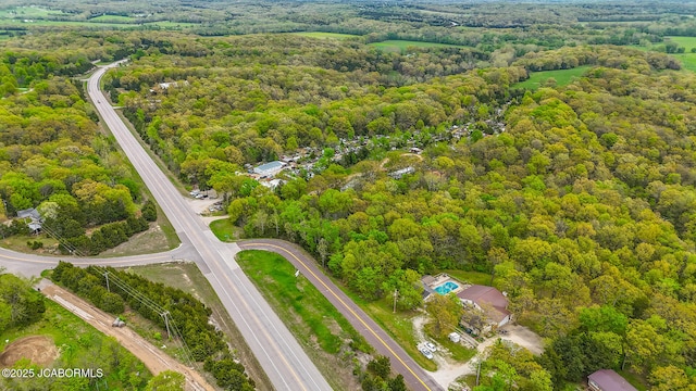 drone / aerial view featuring a forest view