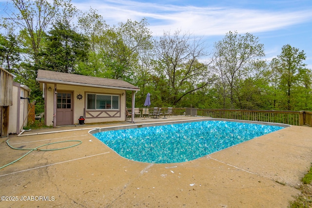 view of pool with a fenced in pool, a patio, and an outdoor structure