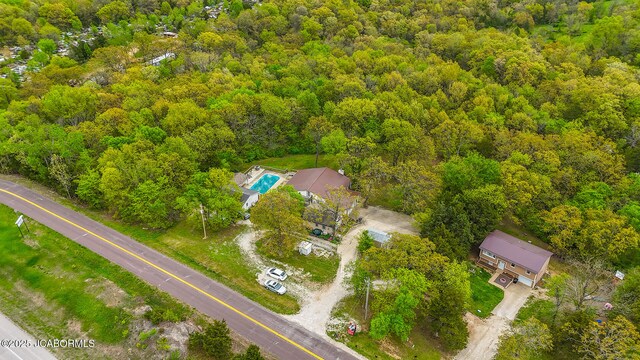 birds eye view of property with a view of trees