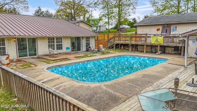 pool with a patio area and a deck