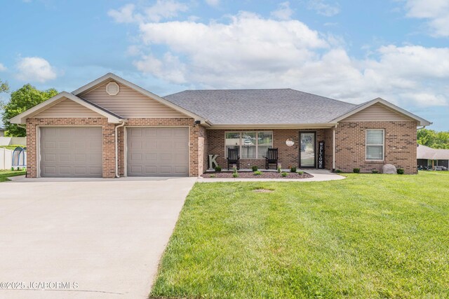 440 Dover Ct, Holts Summit, MO 65043 - view of front facade featuring an attached garage, a front lawn, concrete driveway, and brick siding