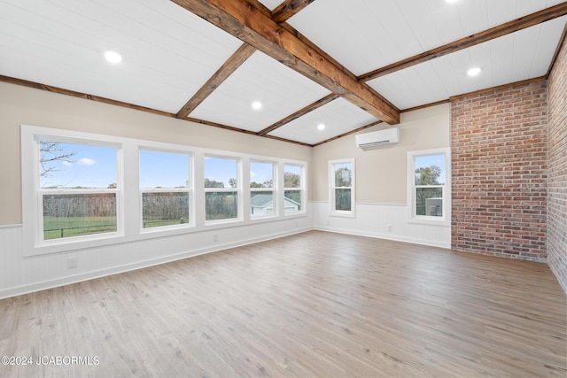 unfurnished living room featuring an AC wall unit, lofted ceiling with beams, brick wall, and wood-type flooring