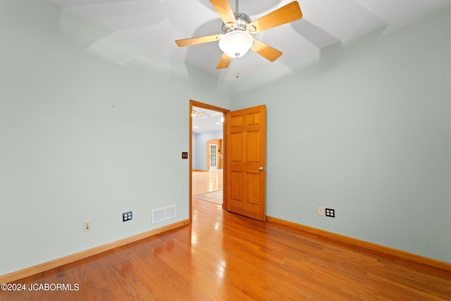 spare room featuring light hardwood / wood-style floors and ceiling fan