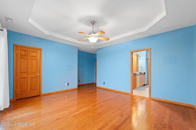 5310 Tebbetts View Dr, Tebbetts, MO 65080 - unfurnished room with baseboards, a raised ceiling, light wood-style floors, visible vents, and ceiling fan