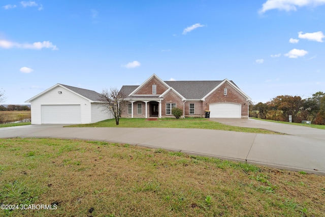 single story home with a garage and a front lawn