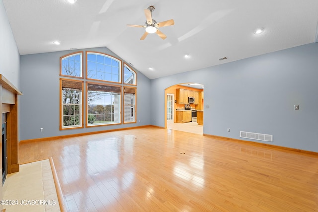 unfurnished living room with vaulted ceiling, light hardwood / wood-style flooring, and ceiling fan