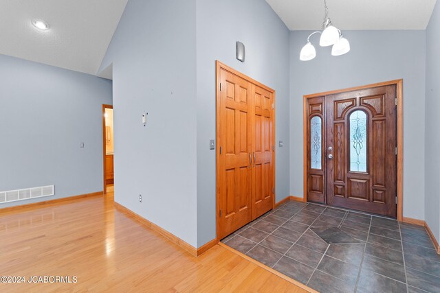 5310 Tebbetts View Dr, Tebbetts, MO 65080 - entryway featuring visible vents, baseboards, high vaulted ceiling, and wood finished floors
