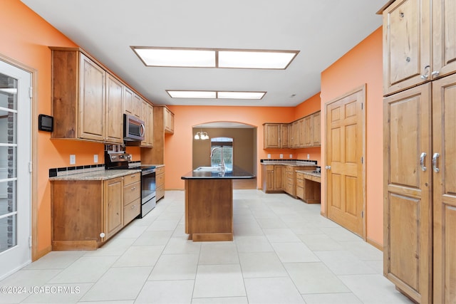 kitchen with a kitchen island, black range with electric stovetop, and sink