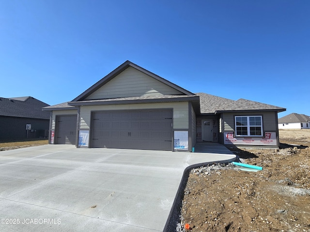 single story home featuring a garage and concrete driveway