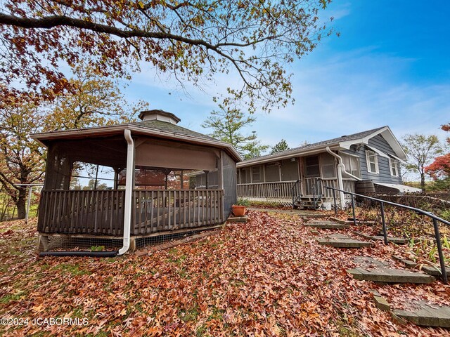 back of property with a sunroom