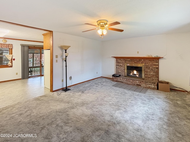 unfurnished living room featuring a fireplace, carpet, and ceiling fan