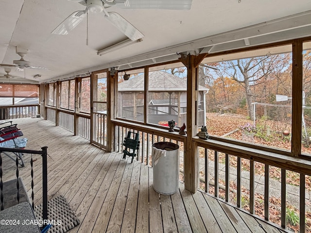 wooden deck featuring ceiling fan and a sunroom