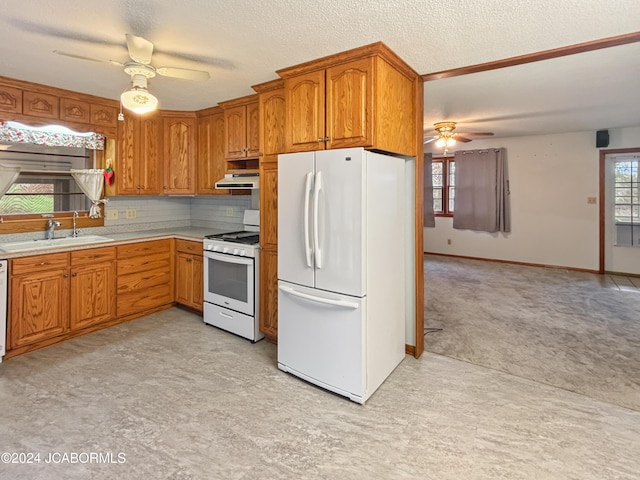 kitchen featuring decorative backsplash, white appliances, ceiling fan, and sink