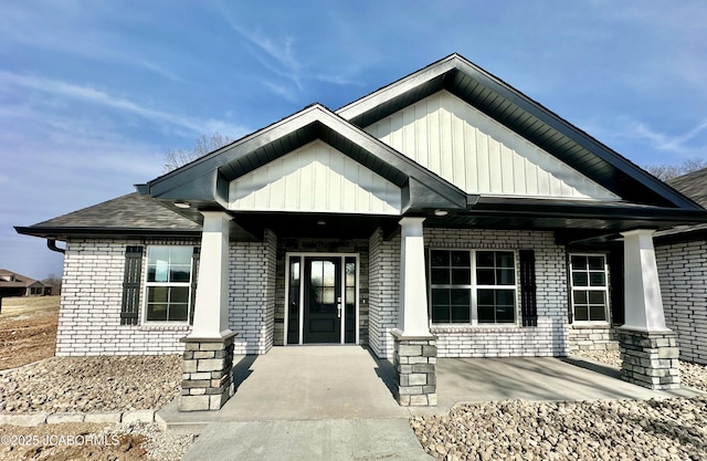 view of front of property featuring covered porch and brick siding