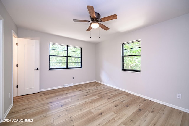 unfurnished room featuring ceiling fan, plenty of natural light, and light hardwood / wood-style floors