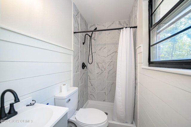 bathroom featuring curtained shower, toilet, and sink