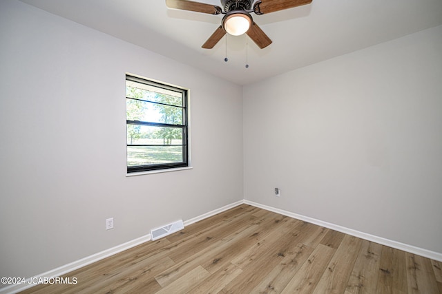 spare room with light wood-type flooring and ceiling fan