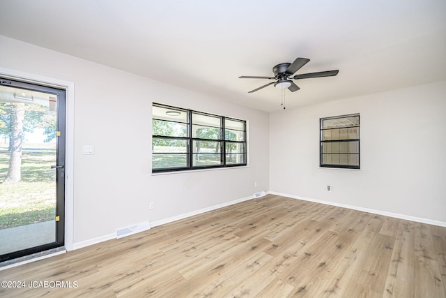 unfurnished room featuring light hardwood / wood-style floors, a wealth of natural light, and ceiling fan