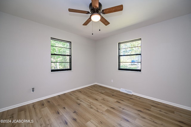 unfurnished room with ceiling fan and light hardwood / wood-style floors