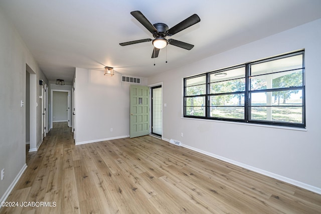 empty room featuring light wood-type flooring and ceiling fan