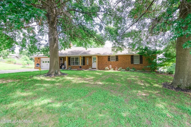 3609 Shamrock Rd, Jefferson City, MO 65101 - single story home with concrete driveway, a garage, a front lawn, and brick siding