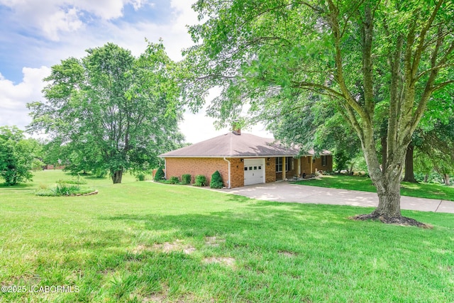 3609 Shamrock Rd, Jefferson City, MO 65101 - view of home's exterior featuring concrete driveway, a garage, a yard, and brick siding