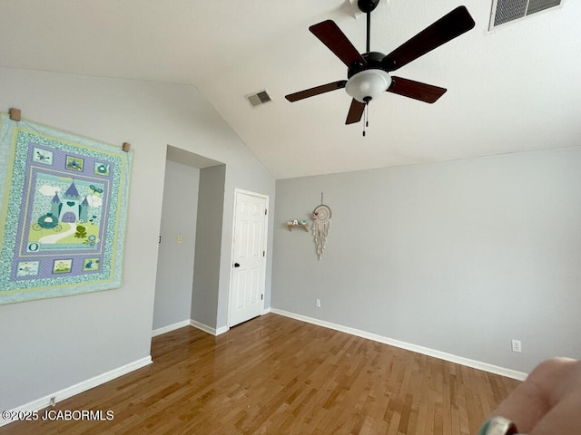 unfurnished room featuring wood-type flooring, ceiling fan, and vaulted ceiling