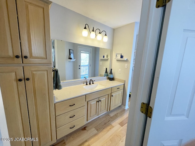 bathroom with hardwood / wood-style flooring and vanity